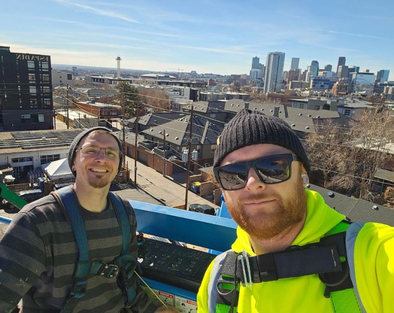 radon mitigation professionals on boom lift
