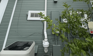 residential radon mitigation system on outside of house